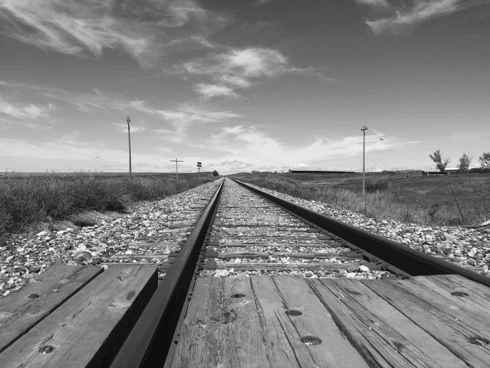 Railway tracks leading off into the horizon somewhere in central Alberta